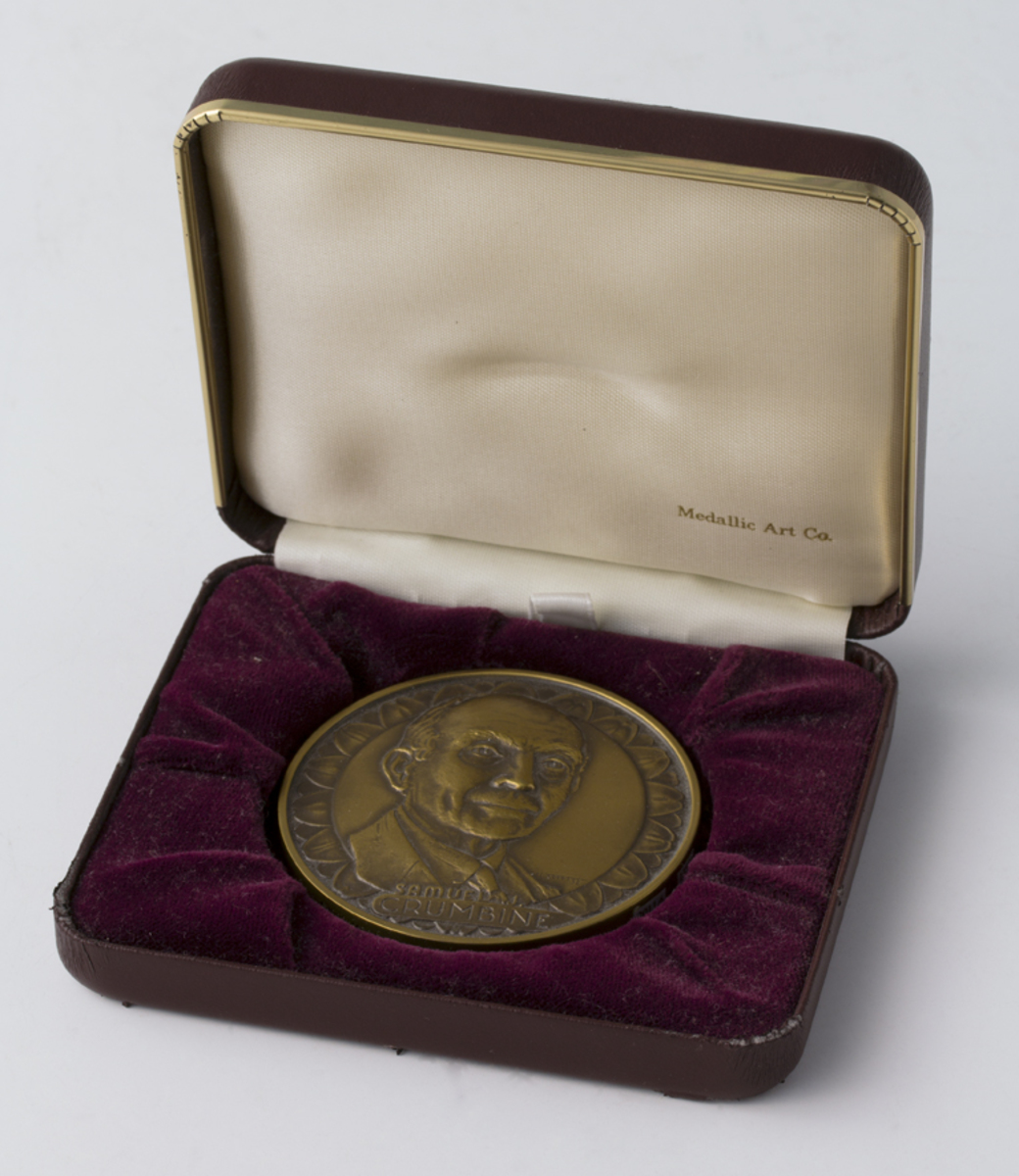 Round bronze medal with a portrait of a man (Dr. Samuel Crumbine) in a rectangular presentation box